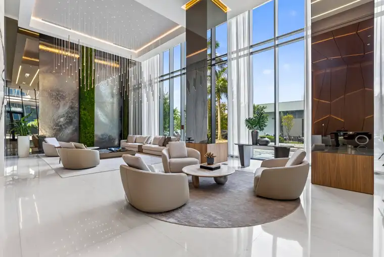 Lobby of a South Florida commercial building with a living wall, water feature and floor-to-ceiling glass