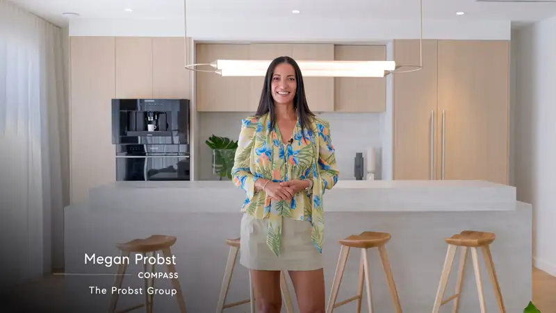 Listing agent introducing a property on camera in a modern kitchen, from a Signature video