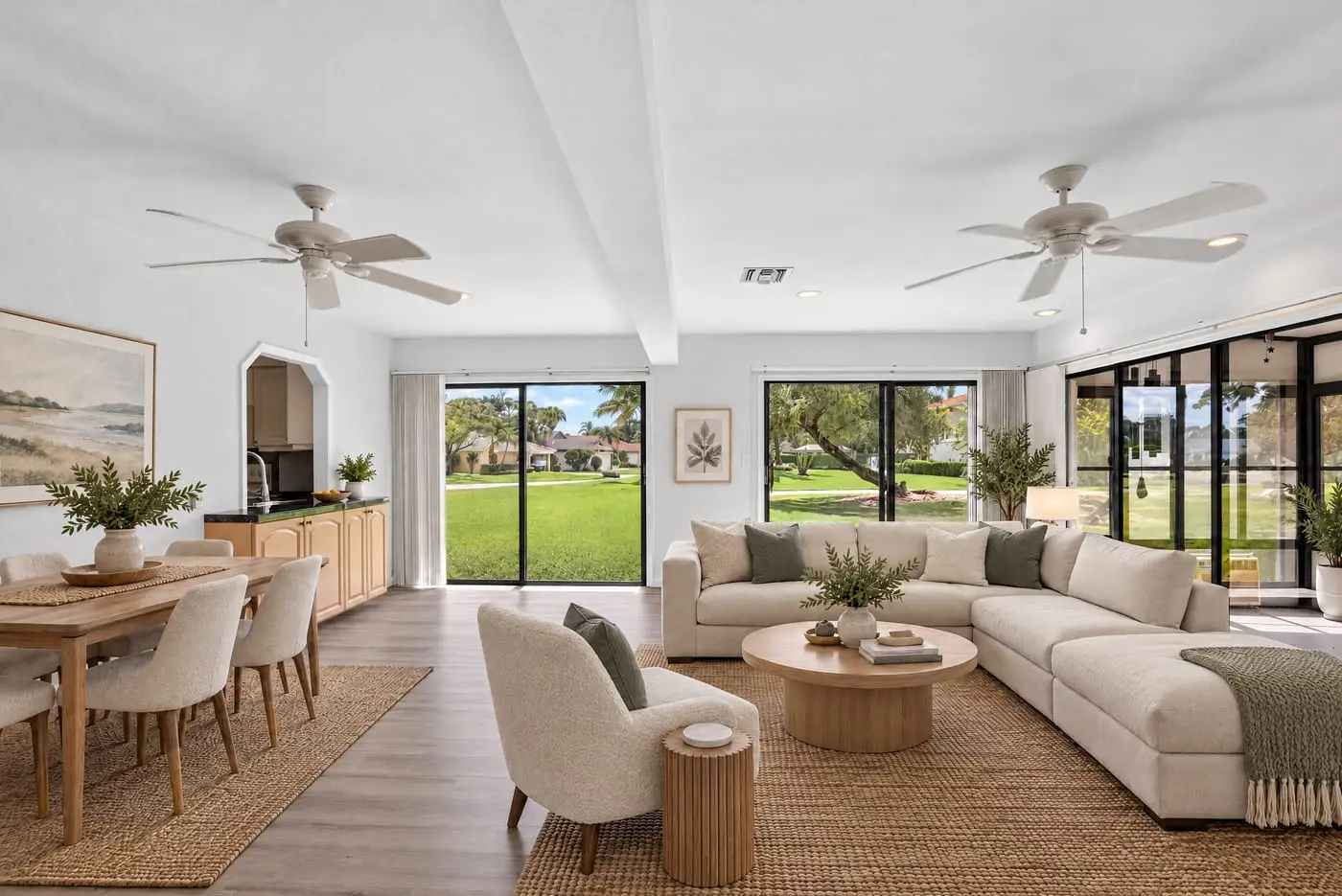 Living room of a South Florida home looking toward the sliding doors, virtually staged